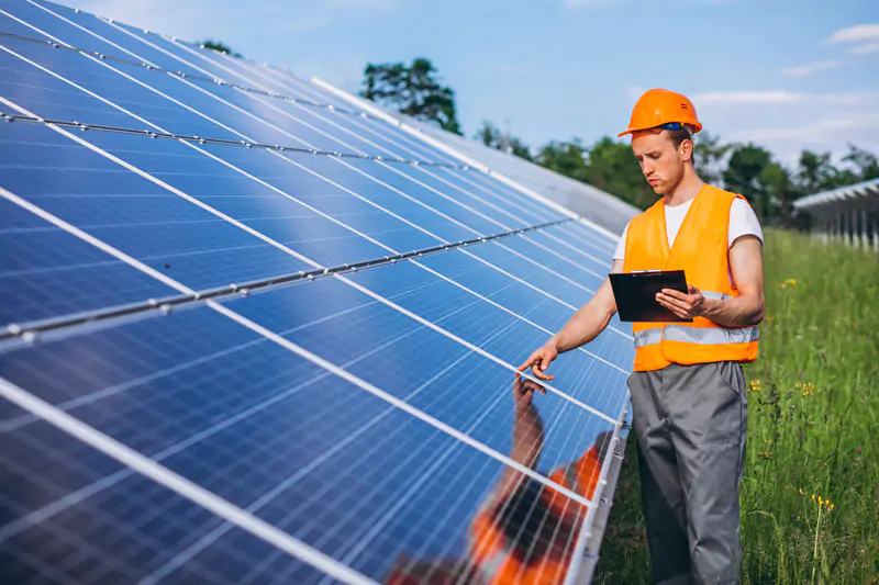 man-worker-firld-by-solar-panels-1.jpg